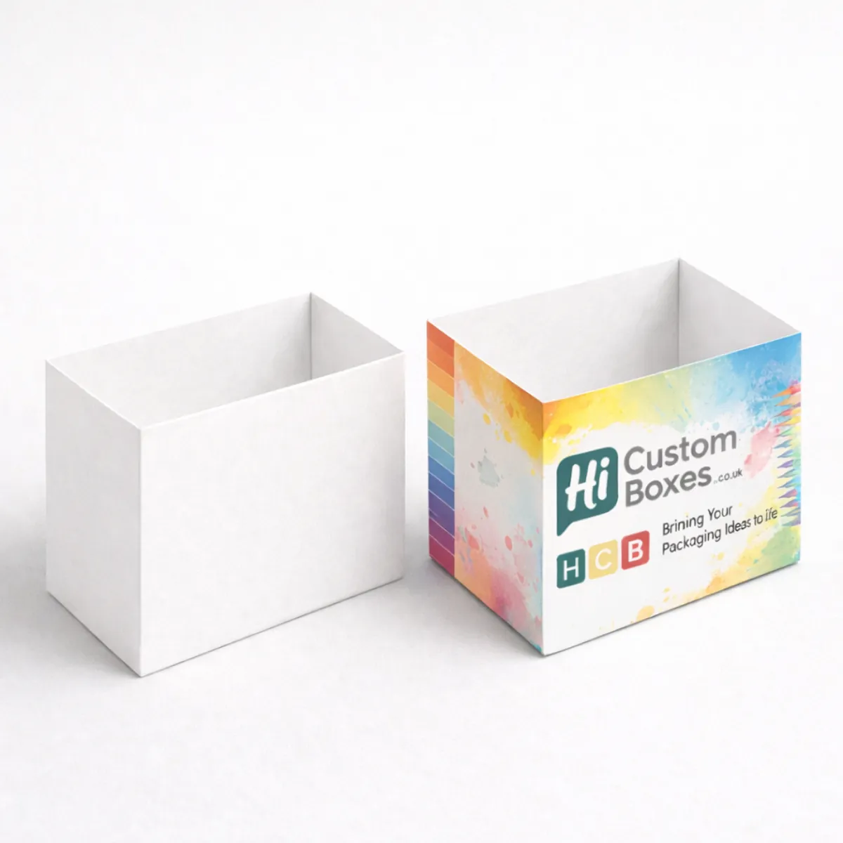 Two small rectangular pencil boxes; one is blank white and the other has a vibrant watercolour paint splash design. class=